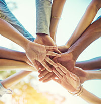 Several people with their arm in together