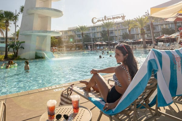 Family sitting on the bed by the window at Cabana Bay Beach Resort.