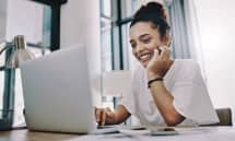 woman smiling working on laptop